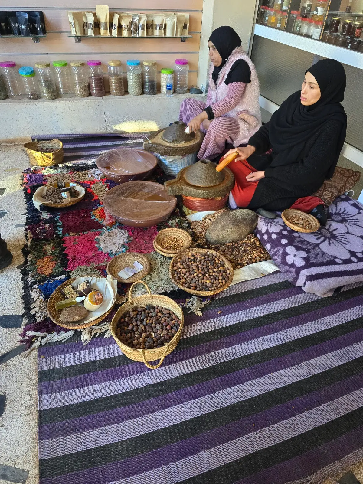 Women of an argan cooperative pressing oil by hand