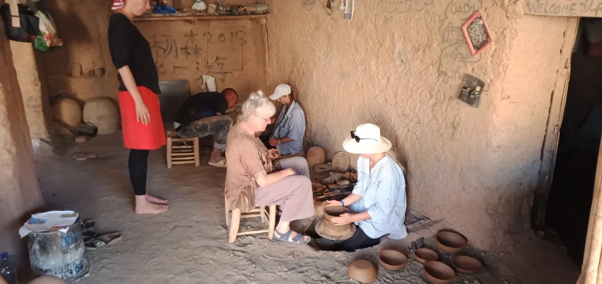 A potter of Agdz shaping clay on a foot-driven wheel